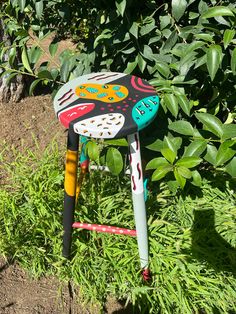 a colorful painted stool sitting in the grass