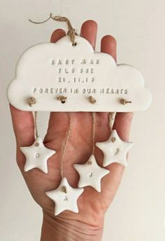 a person holding a white cloud with stars hanging from it