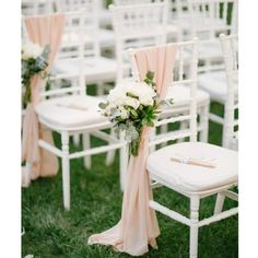 an outdoor ceremony with white chairs and pink sashes