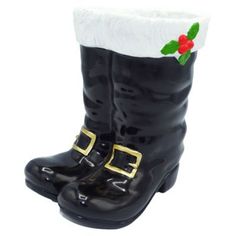 a pair of black boots with holly decorations on them