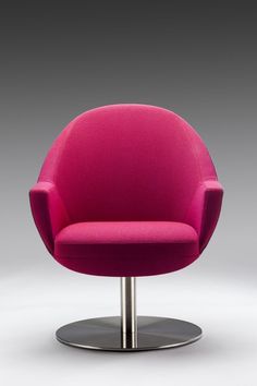 a bright pink chair sitting on top of a metal base in front of a gray background