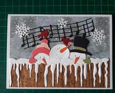 a christmas card with snowmen and musical notes