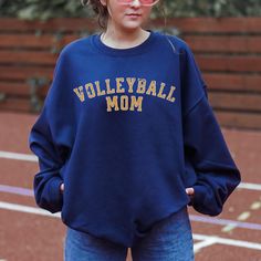 Volleyball Mom Sweatshirt, Volleyball Mom Sweater, Custom Name Volleyball Mom Hoodie, Volleyball Mama Sweatshirt We add color and size charts to each for references so please make sure that you are selecting carefully. Once an order is received it goes into production and we are unable to cancel orders. ABOUT: :) This pre-shrunk, classic fit sweatshirt is made with air-jet spun yarn for a soft feel and reduced pilling. :) Pre-shrunk :) Classic fit with no center crease :) 1x1 athletic rib knit c Sporty Cheerleading Hoodie With Letter Print, Sporty Letter Print Hoodie For Cheerleading, Collegiate Moisture-wicking Sweatshirt For Sports, School Spirit Sweatshirt With Team Name For Sports, Collegiate Sports Sweatshirt With Team Name, Sporty Sweatshirt With Team Logo For Sports, Sporty Sweatshirt With Team Logo, Team-colored Sweatshirt For Sports Season, School Spirit Sports Hoodie With Crew Neck