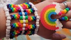 two bracelets that are on someone's arm and one is made out of beads