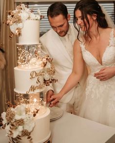 a newly married couple cutting their wedding cake