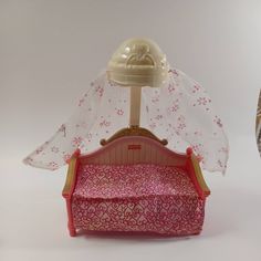 a doll bed with a canopy over it