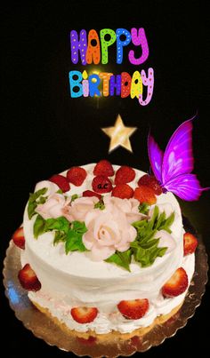 a birthday cake with white frosting and strawberries on the top is decorated with flowers, leaves and a butterfly