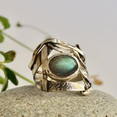 "A Labradorite ring with a brutalist style. Made of sterling silver this raw ring is a piece abstract and rough jewelry. With a distressed and rustic look, this ring is perfect for a viking soul. It's a free form ring, made playing with the silver, looking for unusual forms. The whole surface was treated with a patina , and then cleaned up, bringing out the drawing with a high contrast. Its touch of color is given by a Labradorite with an incredible color and iredescence. This is a piece for raw Jewelry Smithing, Raw Ring, Freeform Ring, Rustic Ring, Rough Jewelry, Rustic Rings, Raw Stone Ring, Top Rings, Jewelry Techniques