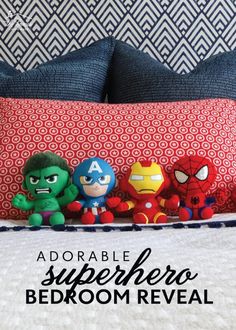 a bed with pillows and stuffed animals on it, the words adorable superhero bedroom reveal