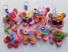 several colorful stuffed animals are hanging from key chains