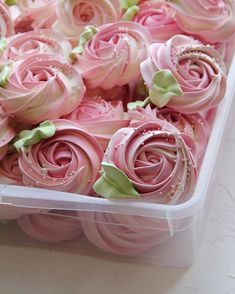 there is a plastic container filled with pink roses