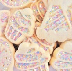 some sugar cookies with white frosting and colorful sprinkles