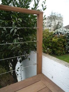 a wooden bench sitting next to a tree