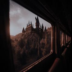 a castle is seen through the window of a train