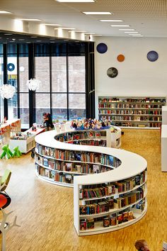 an empty library with lots of books on the shelves and children's toys in the corner