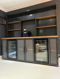 an empty room with shelves and glass doors