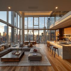 a living room filled with lots of furniture and large windows overlooking the cityscape