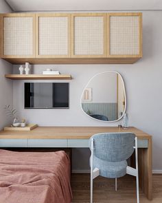 a bedroom with a bed, desk and mirror on the wall next to each other