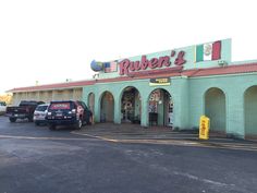 the exterior of a restaurant called ruben's with cars parked in front of it