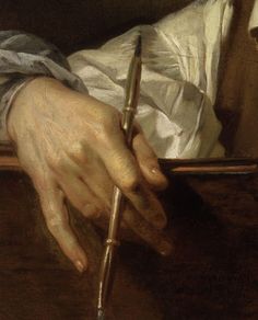 a close up of a person writing on a piece of paper with a pen in their hand