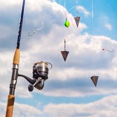 several fishing rods are hanging in the air with balls and lures attached to them