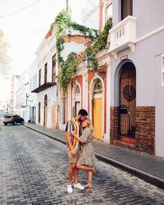 a man and woman kissing on the street