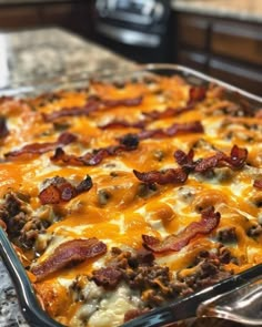 a casserole dish with meat and cheese in it sitting on a counter top