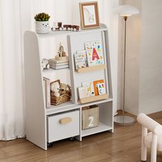 a white book shelf filled with books and toys