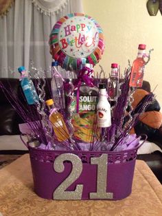 the 21st birthday gift basket is filled with liquor and confetti