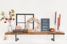 a shelf with some books and candles on it