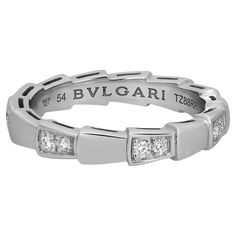 Bvlgari captures the power of seduction in this Serpenti Viper wedding band ring. Sophisticated and glamorous, this ring coils around the finger striking with the precious beauty of the scales. Crafted in lustrous 18K white gold. Total diamond weight: 0.21 carat. Ring size: 54 US 7.25. Band width: 3.5mm. Total weight: 4.93 grams. Made in Italy. Condition: New without tags. Comes with an original box and paper. Power Of Seduction, Bvlgari Serpenti, Simple Gowns, Diamond Band Ring, Wedding Band Ring, Diamond Rings Bands, Diamond Band, Diamond Bands, Wedding Ring Bands