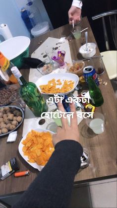 the table is full of food and drinks for two people to enjoy it with their hands