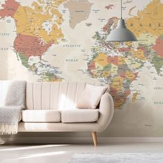 a couch sitting in front of a wall with a map on it