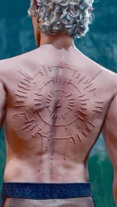 the back of a man's body with sundials drawn on his chest