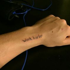 a man's arm with the word woft harder tattooed on it