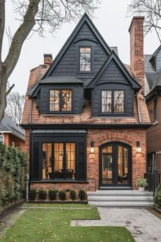 a black and brown house with lots of windows