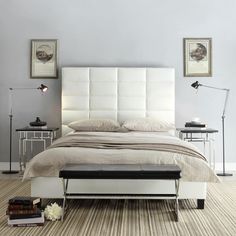 a white bed sitting on top of a wooden floor