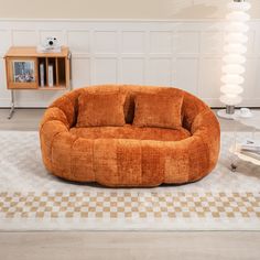 a large round couch sitting on top of a checkered floor