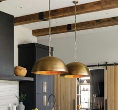 a kitchen with two lights hanging from the ceiling