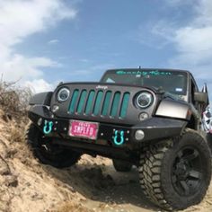 a black jeep driving down a dirt road