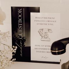 a book sitting on top of a table next to a faucet and flowers