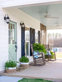 a porch with rocking chairs and potted plants