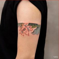 a woman's arm with a flower tattoo on the left side of her arm