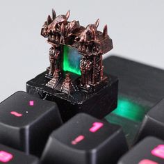 a computer keyboard with two small figurines sitting on it's backlit keys