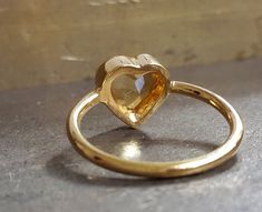 Inspired by a famous graffiti in TLV, the second picture, the citrine heart ring is a trendy choice for anniversaries, engagements, birthdays. Citrine ranges from bright yellow to honey color--one of the Sacral Chakra's essential stones. Positive qualities include making the owner lighthearted and hopeful. It is also associated with prosperity and success, relaxes the body, helping cleanse it of toxins. Birthstone - Scorpio, November Ring - 14k yellow gold, 18k yellow gold, 1.6mm shank Gemstone Gift Heart Ring With Rose Cut Diamonds, Heart Cut Rose Diamonds Heart Ring, Yellow Gold Heart Ring With Gemstone For Gift, Heart Cut Sapphire Ring Birthstone Gift, Unique Yellow Gold Birthstone Ring For Anniversary, Handmade Yellow Gold Birthstone Ring For Anniversary, Heart Shaped Rose Cut Diamond Ring For Gift, Heart Shaped Wedding Ring With Bezel Setting, Heart-shaped Wedding Ring With Bezel Setting