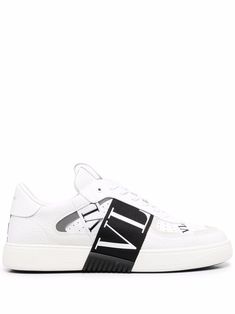 White/black leather VL7N low-top sneakers from VALENTINO GARAVANI featuring round toe, front lace-up fastening, logo-print strap, perforated detailing, logo patch at the tongue and flat rubber sole. White Calf Leather Sneakers With Embossed Logo, Designer White Sneakers With Embossed Logo, Low-top Calf Leather Sneakers With Logo, Low-top Logo Embellished Sneakers For Streetwear, Designer White Sneakers With Logo, Luxury White High-top Sneakers With Logo, Low-top Custom Sneakers In Calf Leather With Perforations, Low-top Calf Leather Custom Sneakers With Perforations, Low-top Perforated Calf Leather Sneakers