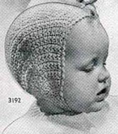 a black and white photo of a baby wearing a knitted hat