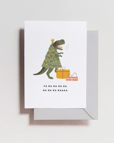 a christmas card with a dinosaur holding a present on it's back and the words happy new year written in spanish