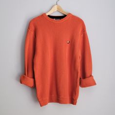 One vintage 1990's pumpkin orange sweater, men's large * Crew neck. * Chevron knit pattern. * Color scheme: pumpkin orange. | SIZE | Marked as a men's Large. ~ Garment laying flat. Double measurements where applicable. ~ Shoulder width: 20 in. * 51 cm. Chest width: 21 in. * 53 cm. Waist width: 18 in. * 46 cm. Length, measured in back: 27 in. * 68.5 cm. | CONDITION | A+. Gently used vintage item. | BRAND | Chaps, by Ralph Lauren. Made in Indonesia. | MATERIALS | 100% cotton. Knit fabric. Orange Winter Sweater With Ribbed Cuffs, Burnt Orange Long Sleeve Winter Sweater, Casual Burnt Orange Sweater For Fall, Orange Crew Neck Sweater With Ribbed Cuffs, Orange Ribbed Cuff Crew Neck Sweater, Casual Orange Crew Neck Sweater, Vintage Orange Sweater For Fall, Pull Orange, Orange Pullover