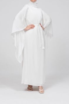 The Eternal Ivory Satin Kimono Sleeve Nikah Maxi Dress is designed for those cherished moments of love and celebration. Crafted from luxurious satin, this dress features a timeless, clean-cut front and gracefully draped extra-long kimono sleeves, offering both elegance and modesty. The detachable belt cinches the waist, creating a flattering silhouette, while the dress's comfortable lining ensures ease of wear. Perfect for special occasions like Nikah or bridal events, this sophisticated maxi dr Elegant Satin Maxi Dress For Wedding, White Silk Satin Finish Dress, White Satin Maxi Gown, Elegant Satin Finish Maxi Dress For Wedding Night, Wedding Maxi Dress With Satin Finish, Elegant White Satin Maxi Dress, Elegant White Satin Silk Dress, Elegant White Satin Finish Dresses, Cream Flowy Maxi Dress For Wedding